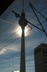 Low angle view of communications tower against sky