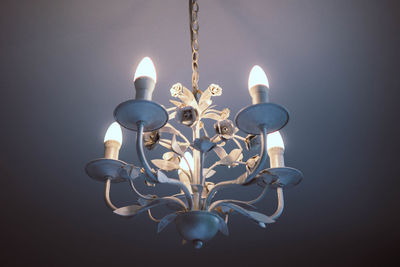 Close-up of illuminated chandelier against black background
