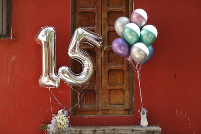 Multi colored balloons on door of building