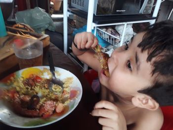 Portrait of boy with food on table