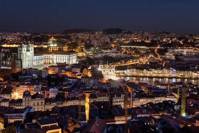 High angle view of city lit up at night