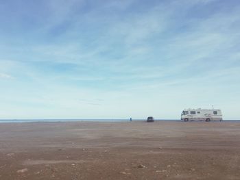 Scenic view of beach against blue sky