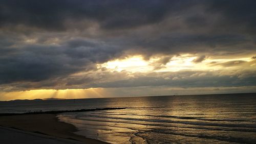 Scenic view of beach at dusk