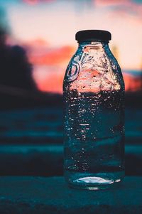 Close-up of water bottle against sky