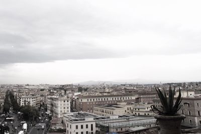 Cityscape against cloudy sky