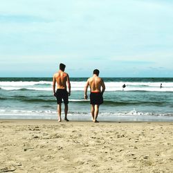 Rear view of men on beach