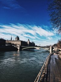 Bridge over river with city in background