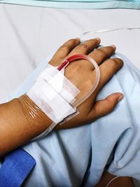 Cropped image of woman hand with iv drip at hospital