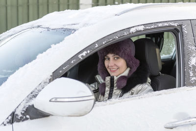 Portrait of smiling young woman in car