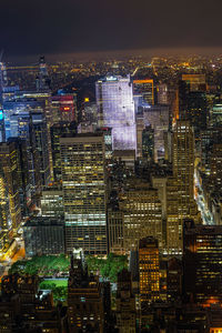 High angle view of illuminated buildings in city at night