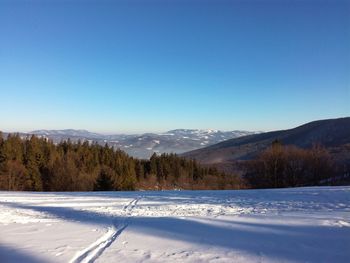 Scenic view of mountains against clear blue sky
