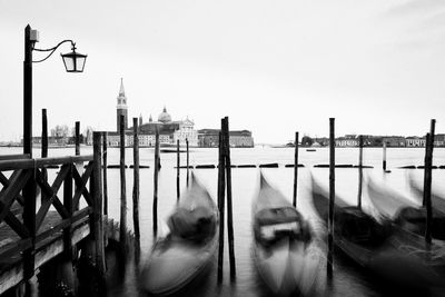 Boats moored at port against church of san giorgio maggiore