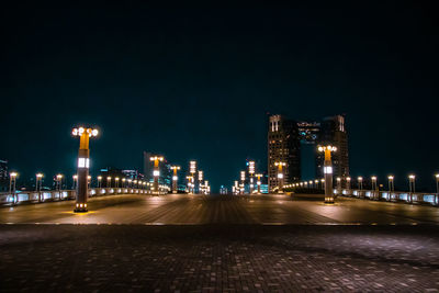 Illuminated street lights on footpath at night