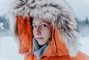 Close-up portrait of mid adult woman wearing fur coat during winter