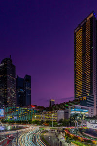 High angle view of illuminated buildings against sky at night