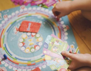 Midsection of person holding multi colored painting