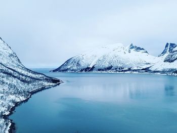 Scenic view of lake against sky during winter