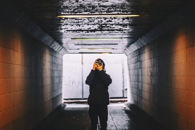 Female photographer in tunnel