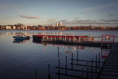 Scenic view of river against sky in city