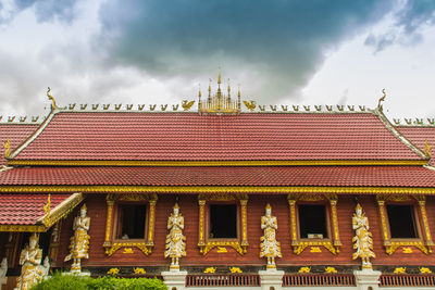 Low angle view of building against cloudy sky