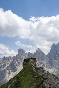 Woman standing on the mountain top overlooking cadini group mountains