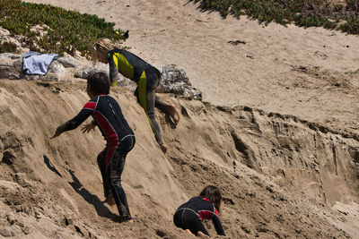 High angle view of men playing on sand