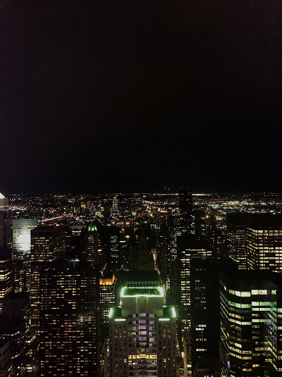 ILLUMINATED BUILDINGS AGAINST SKY AT NIGHT