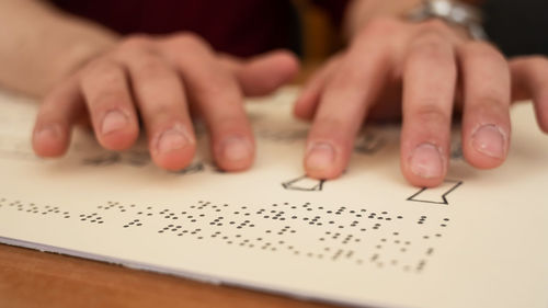 Midsection of woman writing on paper