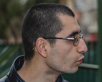 Close-up portrait of young man wearing eyeglasses