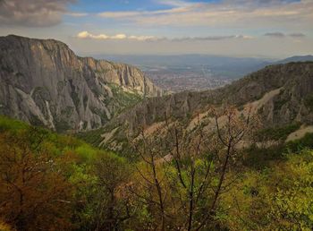 Scenic view of mountains against cloudy sky