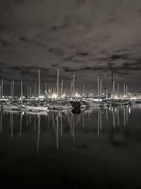 Sailboats in sea against sky at night