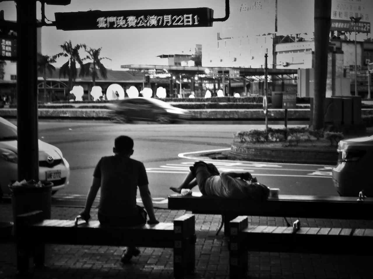 PEOPLE SITTING ON ROAD