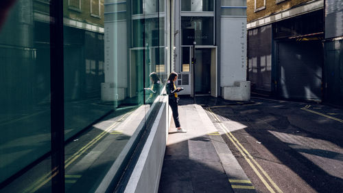 Man walking on modern building in city