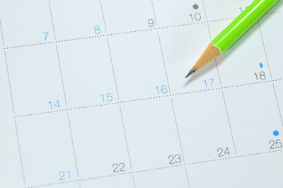 High angle view of pencil on calendar