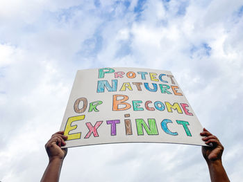 Hands holding sign about climate change