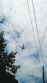 Low angle view of airplane flying in sky