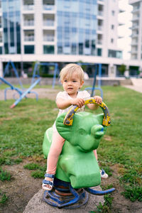 Full length of boy holding toy in park