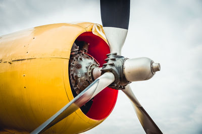 Close-up of propeller against cloudy sky