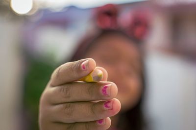 Close-up of woman hand holding blurred background