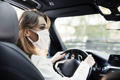 Portrait of woman sitting in car