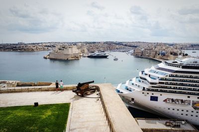 High angle view of sea by city against sky