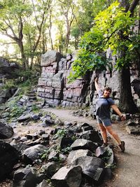 Full length of man climbing on rock