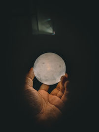 Close-up of hand holding candle