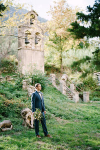 Full length of man standing by tree