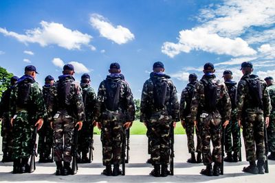 Army soldiers standing side by side on street