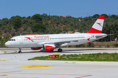 Airplane on runway against clear sky