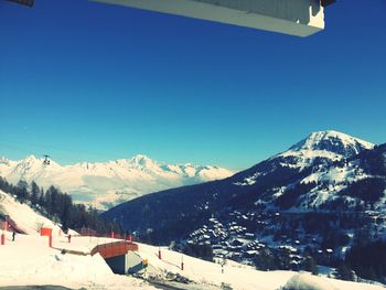 Scenic view of snowcapped mountains against blue sky