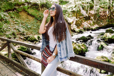 Young woman standing on footbridge