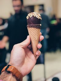 Close-up of hand holding ice cream cone