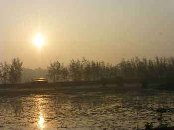 Scenic view of lake against sky during sunset